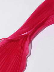 Close-up of a red pleated fabric on a light gray background