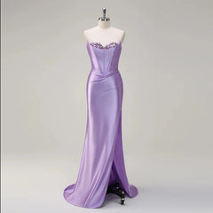 Purple evening gown on a mannequin against a gray background