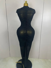 Black sheer dress on a mannequin against a white background