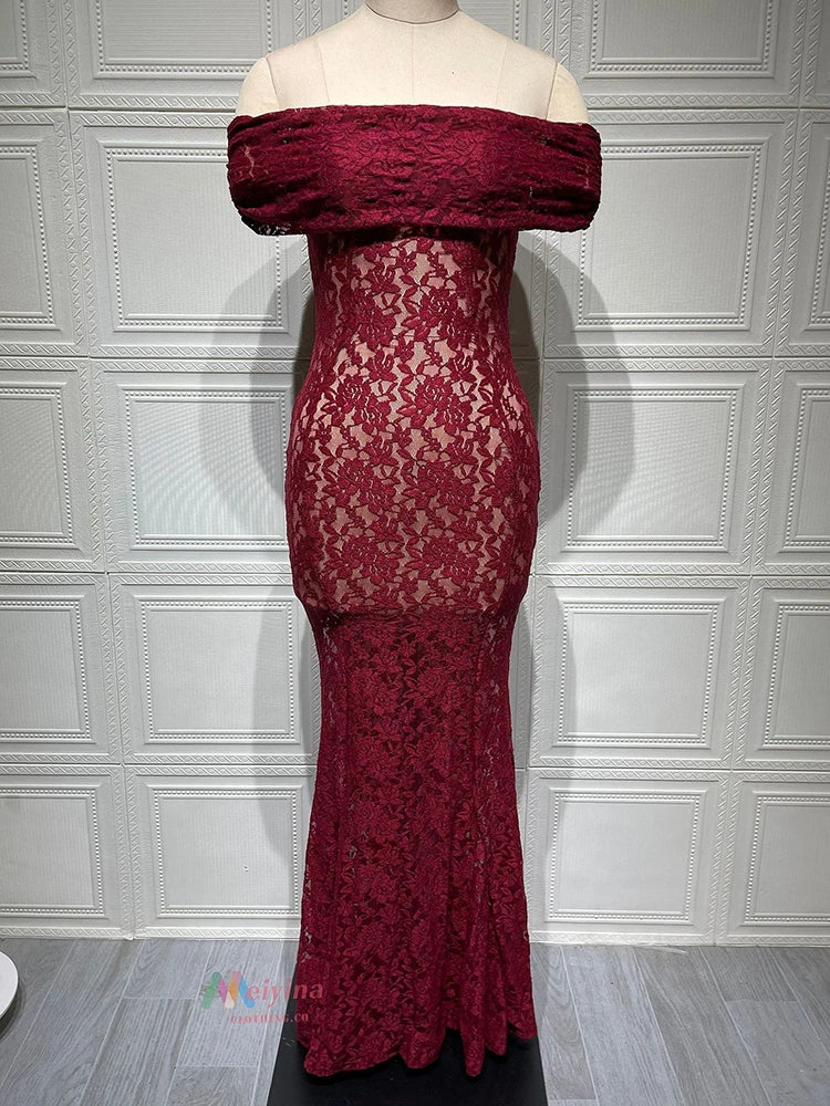 Red lace off-shoulder dress on a mannequin against a white paneled wall.