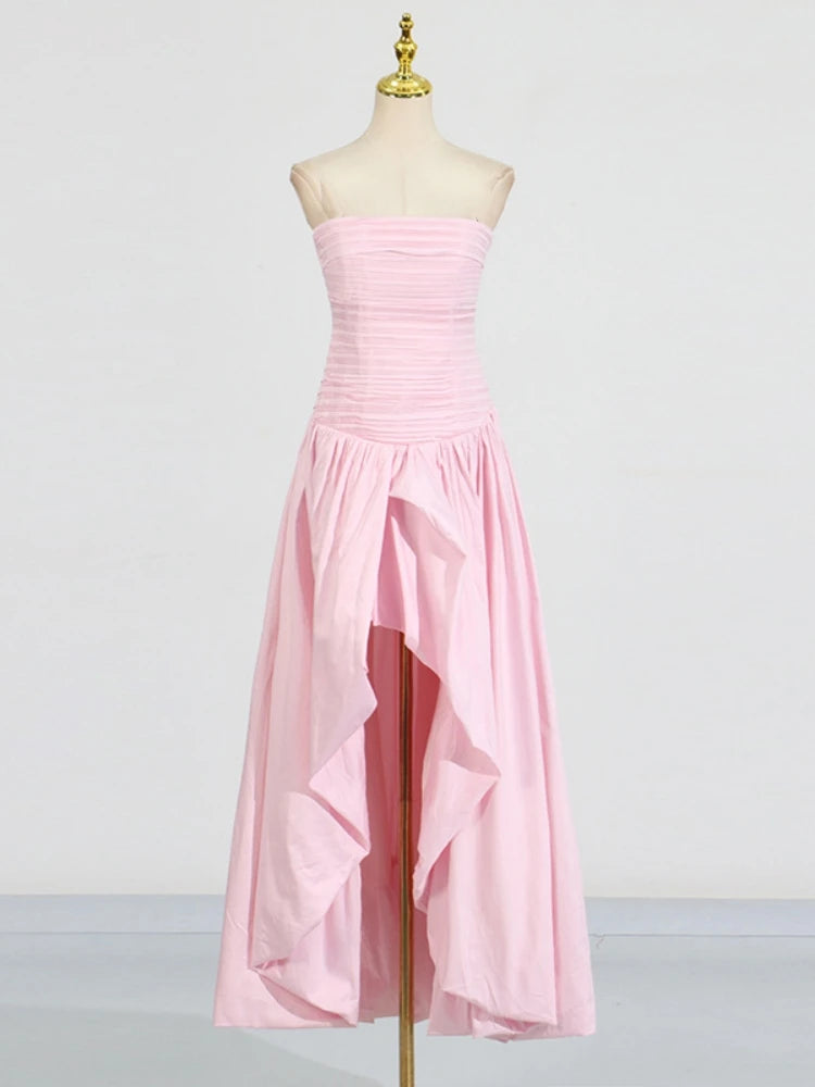 Pink strapless dress on a mannequin against a plain background