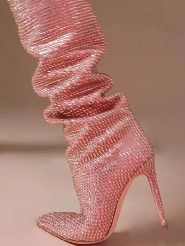 Close-up of a pink crystal embellished over the knee boot shaft.