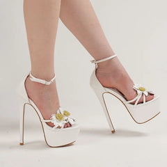 White high-heeled sandals with floral details