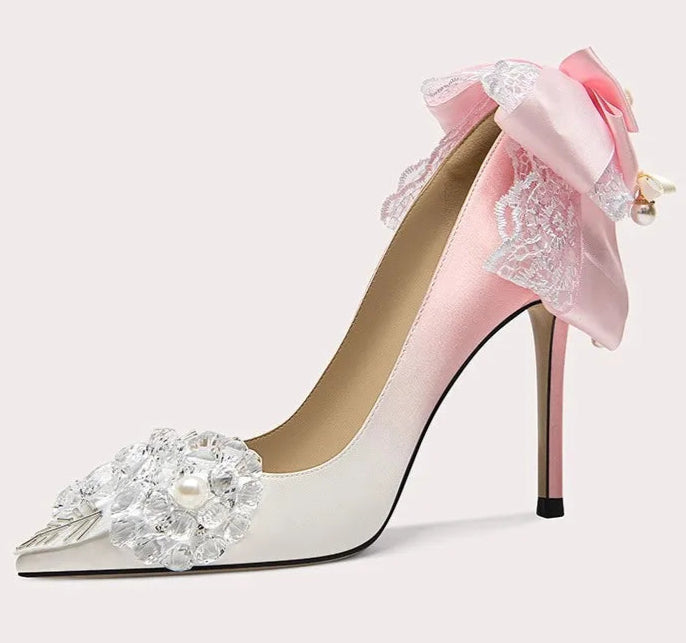 Pink high-heeled shoe with floral design on a white background