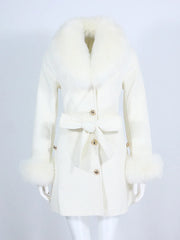 White coat with fur collar on a mannequin against a light gray background