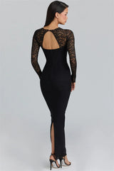 Black lace dress with long sleeves and a back slit on a gray background