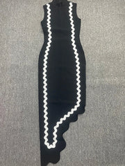 Black dress with white zigzag pattern on a gray surface