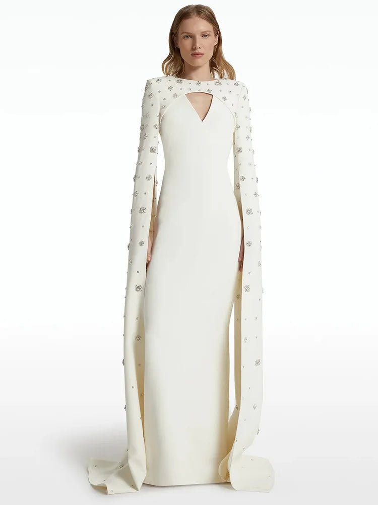 White maxi dress with beaded cape sleeves and neckline cut-out