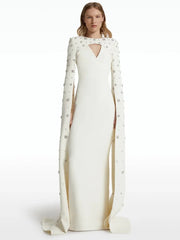 White maxi dress with beaded cape sleeves and neckline cut-out