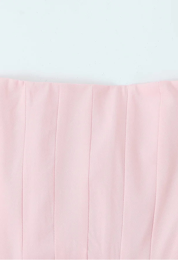 Pink strapless top on a light gray background