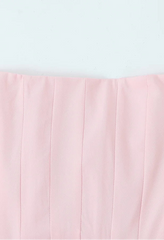 Pink strapless top on a light gray background