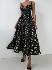 Black floral dress worn by a person on a white background