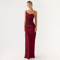 Woman wearing a burgundy evening gown on a white background