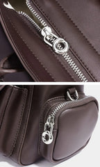 Close-up of a brown bag with a silver zipper on a white background