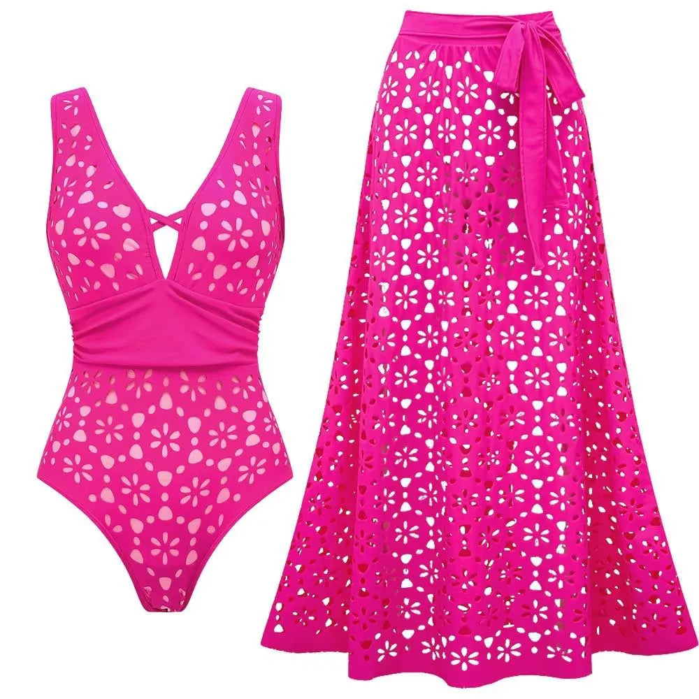 Deep V-neck one-piece swimsuit with eyelet details and tie-waist midi skirt in pink.