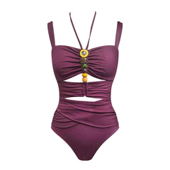 Close-up of the ruched swimsuit featuring beaded embellishments on the bust.