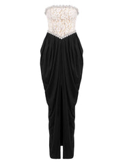 Black strapless gown with floral embellishments on a white background