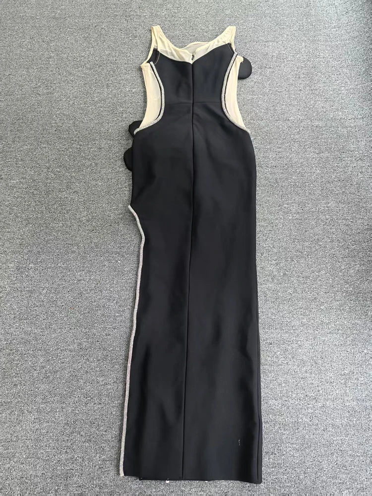 Black dress with white trim on a gray background