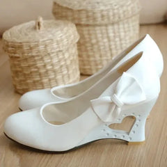 Patent leather round toe slip-on pumps with butterfly knot detail