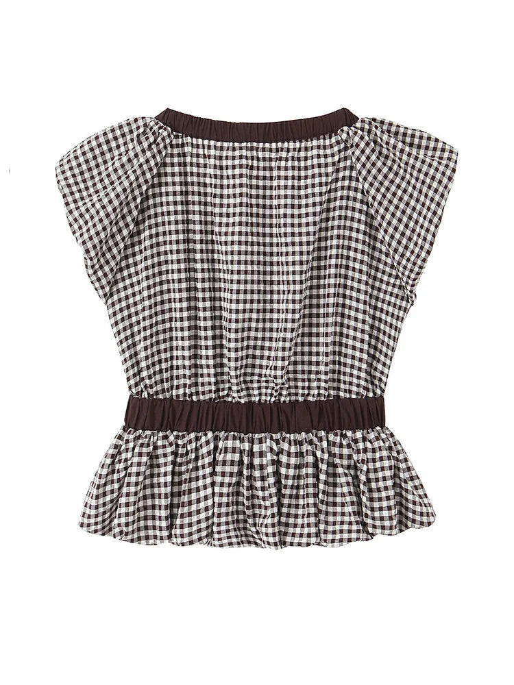 Black and white checkered top with a brown belt on a white background