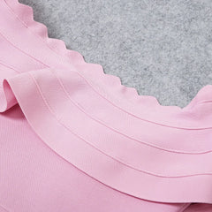 Close-up of pink fabric with a textured gray background