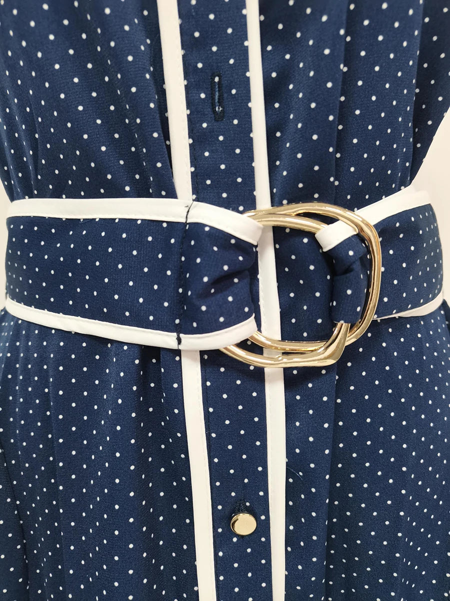 Navy blue dress with white polka dots and a gold belt buckle.