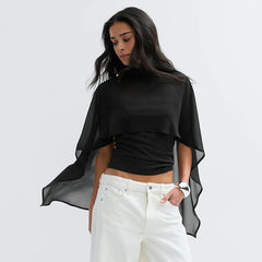 Sheer cape overlay high neck top with white pants