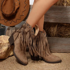 Brown fringe boots with a cowboy hat and wooden bench in the background