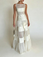 O-neck sleeveless maxi dress with mesh and satin panels in studio setting