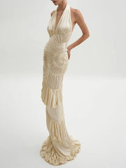 Beige evening gown with ruffled details on a white background