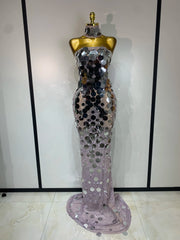 Mannequin wearing a silver sequin evening gown against a plain background