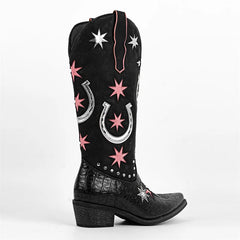 Black cowboy boot with pink star and silver horseshoe patterns on a white background
