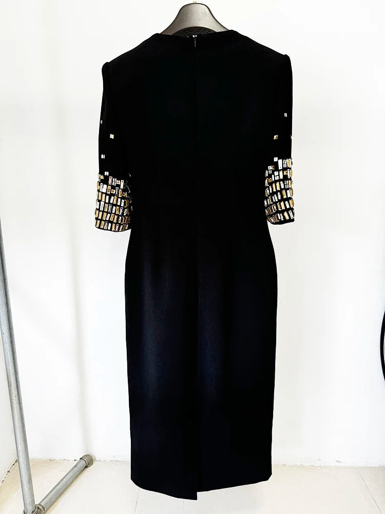 Black midi dress with embellished sleeves on a mannequin