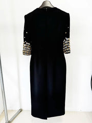 Black midi dress with embellished sleeves on a mannequin