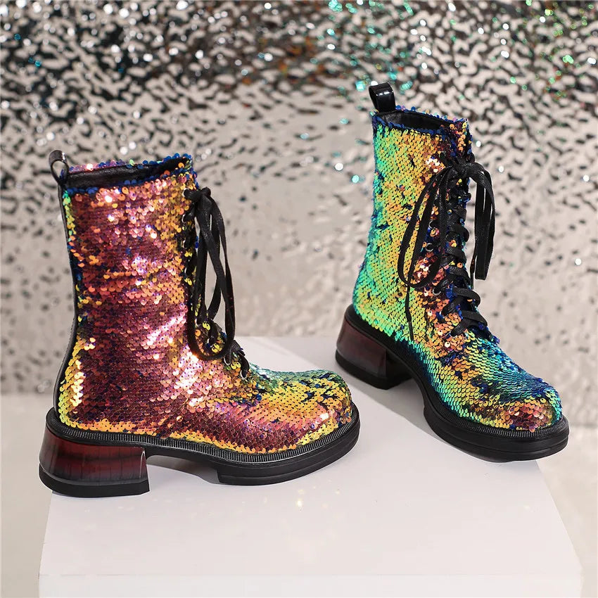Pair of sequin boots with a multicolor pattern on a reflective surface.