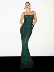 Woman wearing a green evening gown on a white background