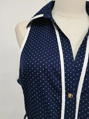 Navy blue shirt with white polka dots on a mannequin