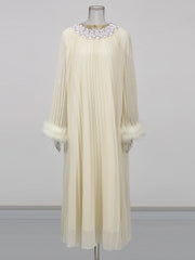 Cream-colored dress with feathered cuffs on a mannequin against a gray background