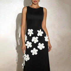 Black dress with white floral patterns on a plain background