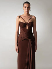 Woman wearing a brown evening gown with a plain background