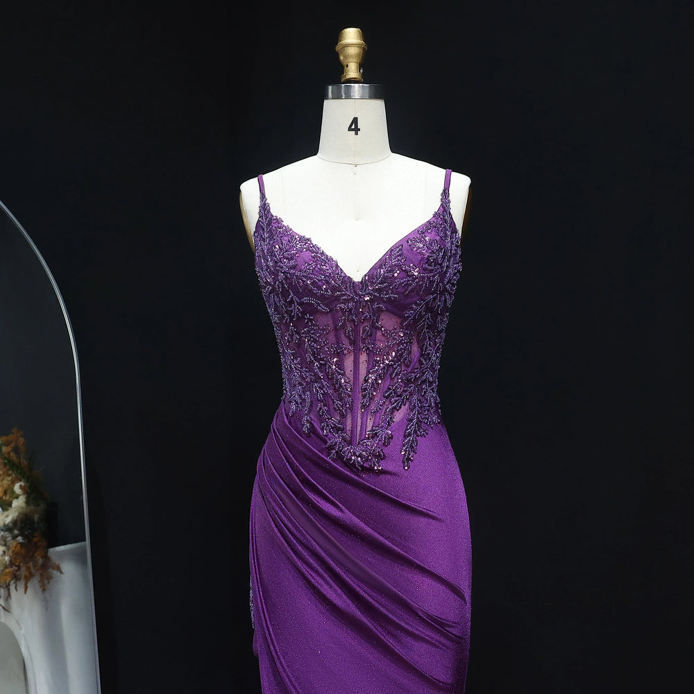 Purple evening gown on a mannequin against a black background