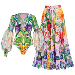 Pink floral print long sleeve bodysuit and tiered maxi skirt laid flat.
