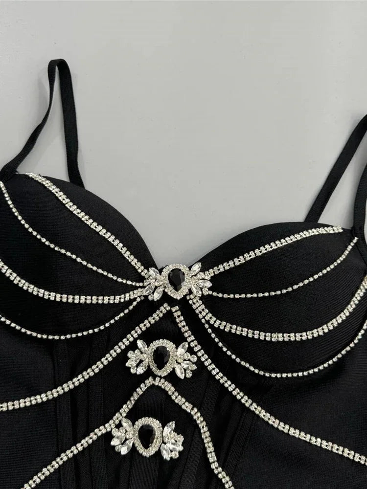 Black dress with intricate silver embellishments on a gray background