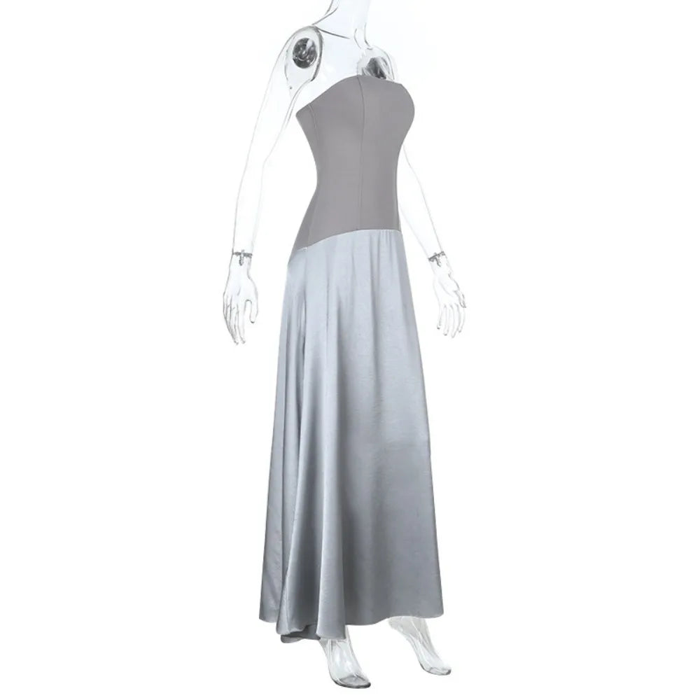Mannequin wearing a strapless gray dress with a flowing skirt on a white background