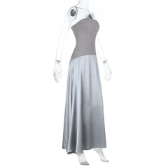 Mannequin wearing a strapless gray dress with a flowing skirt on a white background