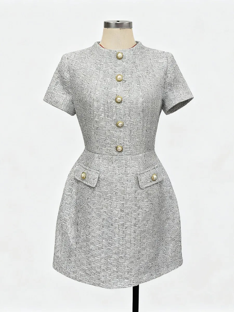 Gray dress with button details on a mannequin against a white background