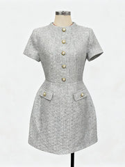 Gray dress with button details on a mannequin against a white background