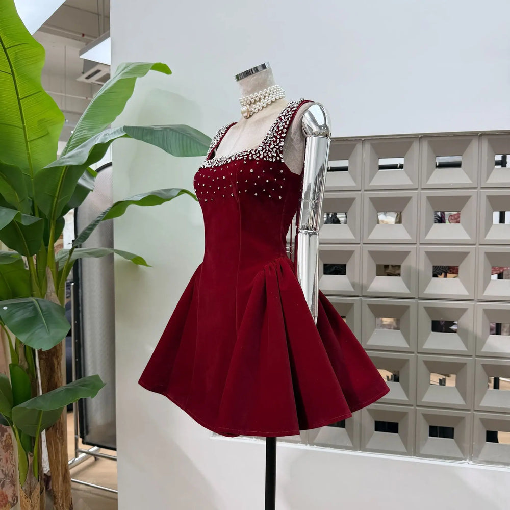 Red dress on a mannequin with pearls against a modern interior background