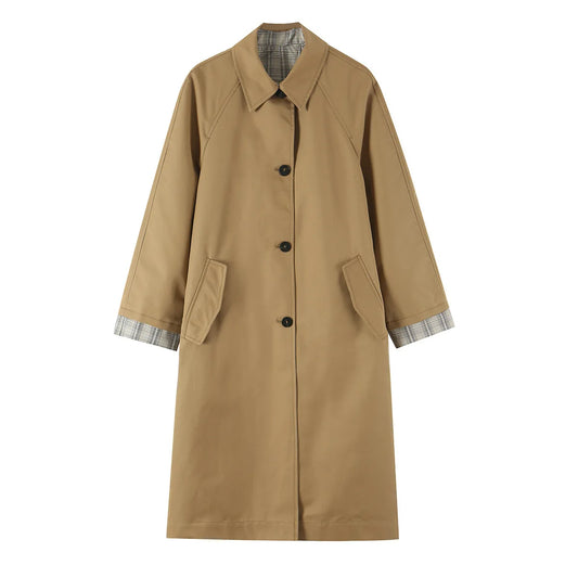 Reversible coat with plaid lining, lapel collar, and button closure.