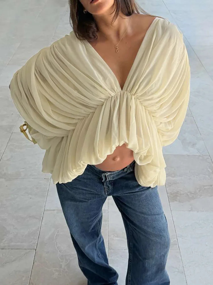 Close-up of the ruched detailing on a batwing sleeve blouse